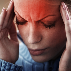 Woman with headache, hands on head